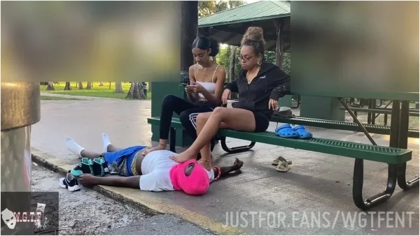 a man lying on the ground with a woman putting on his foot
